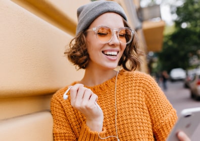a girl with a phone in headphones