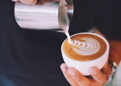 coffee is poured into a cup